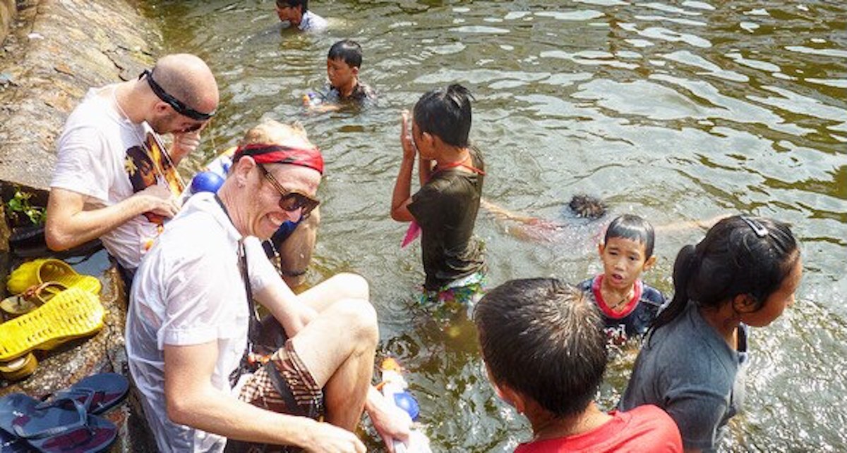 Songkran in Chiang Mai: 2024 Guide To Thailand's Water Festival! | in moat chiang mai songkran Tourists smile in a moat during Songkran festival