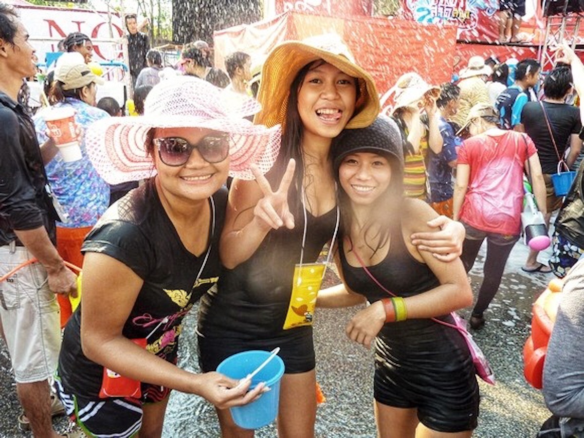 Songkran in Chiang Mai: 2024 Guide To Thailand's Water Festival! | thai girls celebrate songkran Thai women smile during Thai Water Festival.