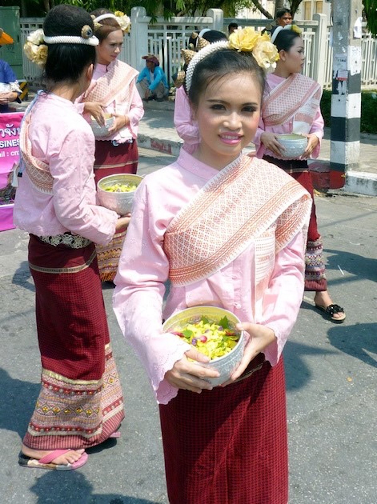 Songkran in Chiang Mai: 2024 Guide To Thailand's Water Festival! | traditional songkran chiang mai A pretty Thai lady in traditional dress smiles at the camera