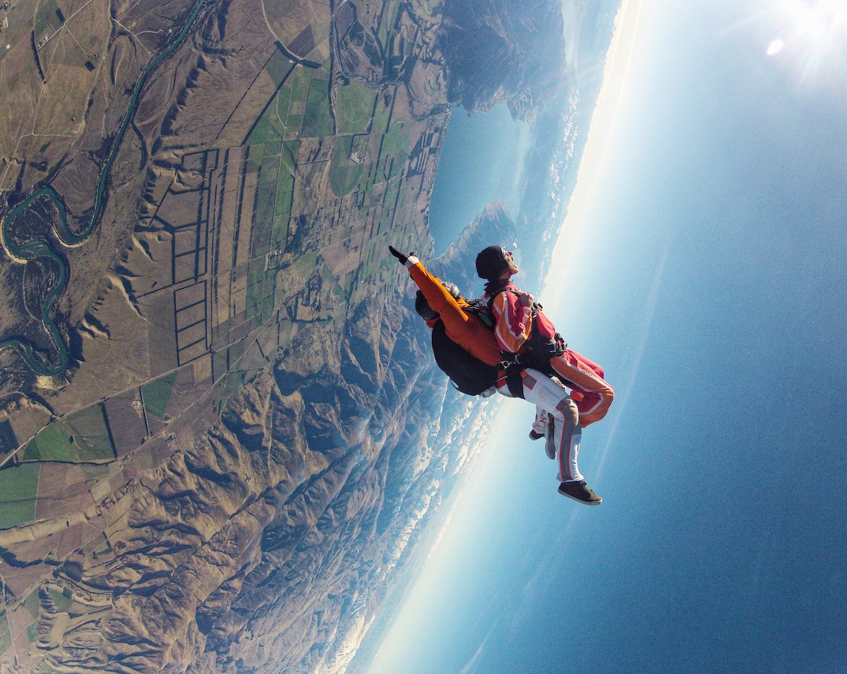 Skydiving in Wanaka Experience: My First Ever Skydive in NZ! | wanaka skydive upside down 2 men are upside down in a tandem skydive jump.