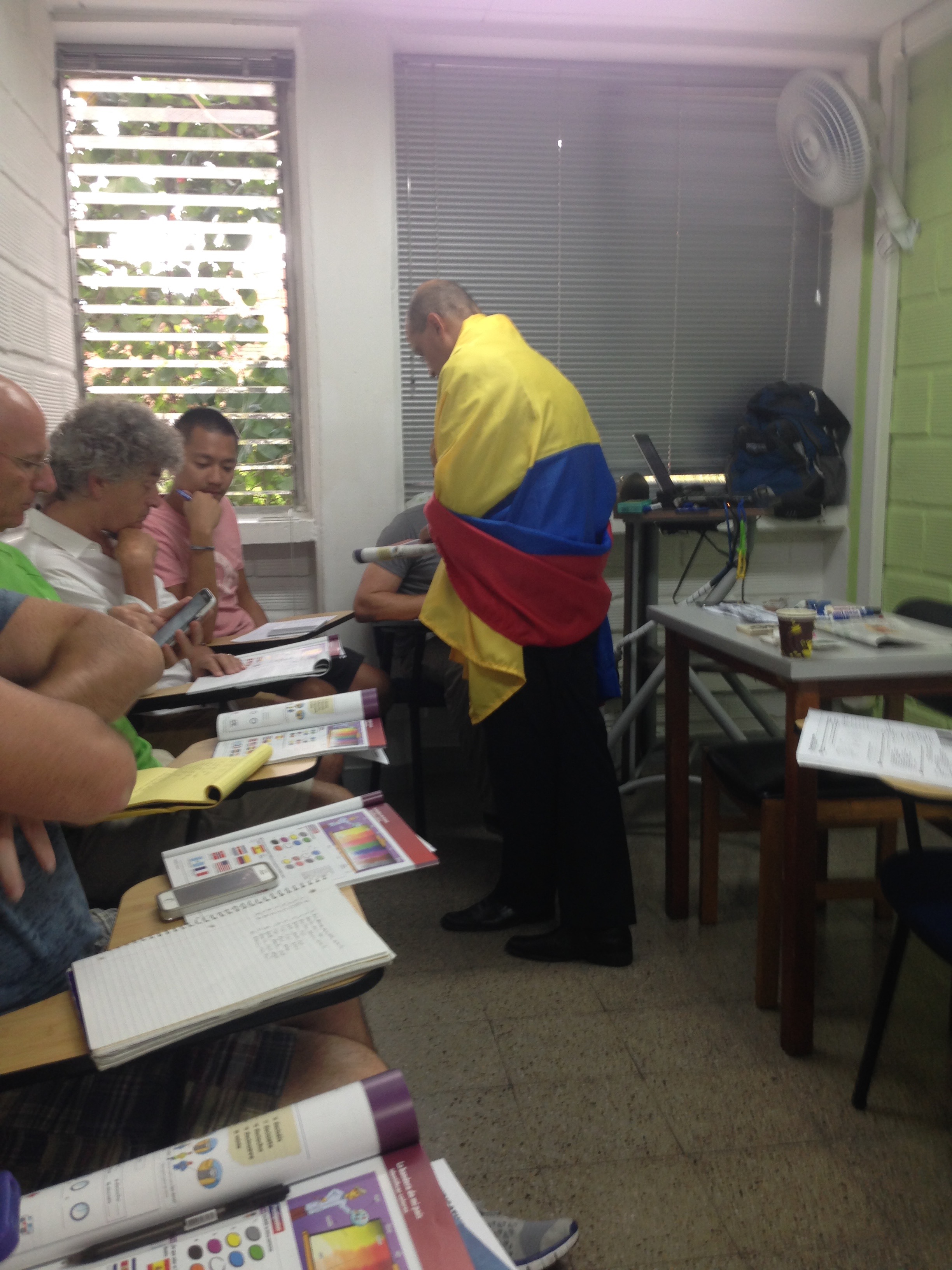11 Honest Reasons To Learn Spanish in Medellin, Colombia | IMG 7696 Crazy Colombian teacher draped in Colombian flag while locals study Spanish in Medellin