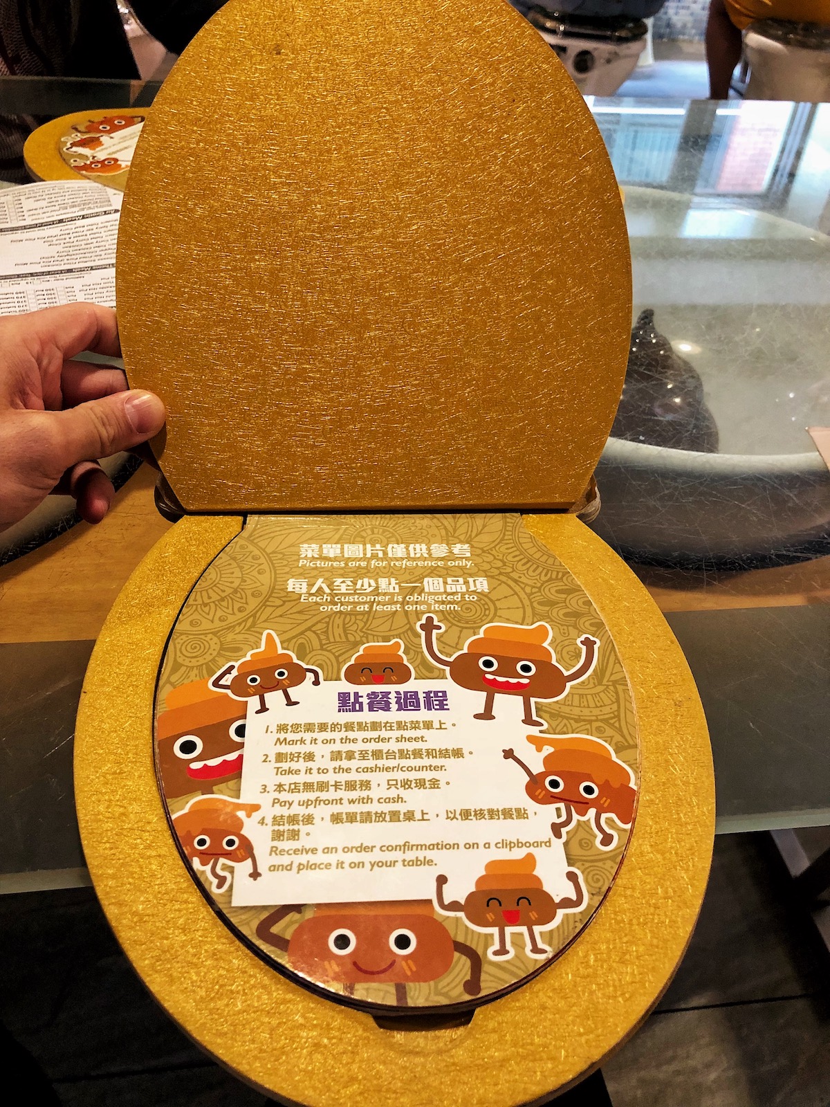 7 Unique & Fun Things To Do in Taipei (Guide For Weirdos!) | Modern Toilet Taipei A menu and instructions in the shape of a toilet seat