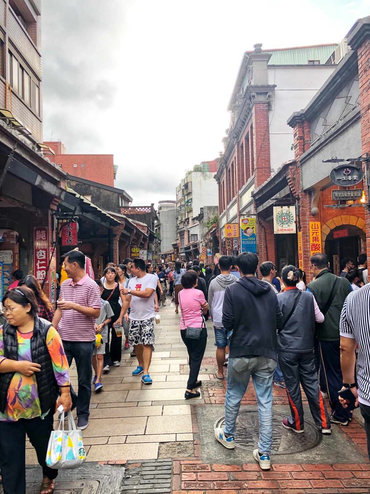 7 Unique & Fun Things To Do in Taipei (Guide For Weirdos!) | Shenkeng Street Taipei A busy, tight street with people walking down both sides of it