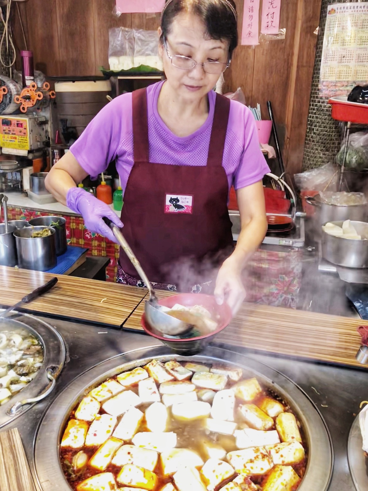 7 Unique & Fun Things To Do in Taipei (Guide For Weirdos!) | Stinky Tofu Taiwan A lady street seller dishes out a huge pot of tofu in Taipei, Taiwan