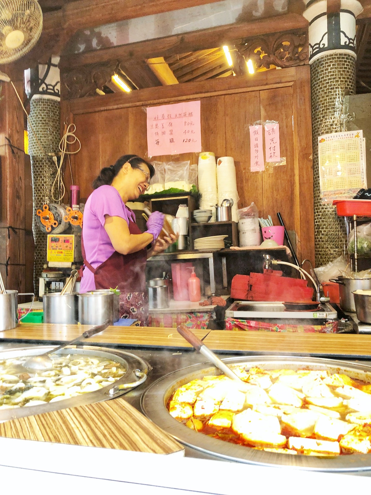 7 Unique & Fun Things To Do in Taipei (Guide For Weirdos!) | Stinky Tofu lady laughing A lady street seller bursts into hysterics while cooking stinky tofu in Taiwan