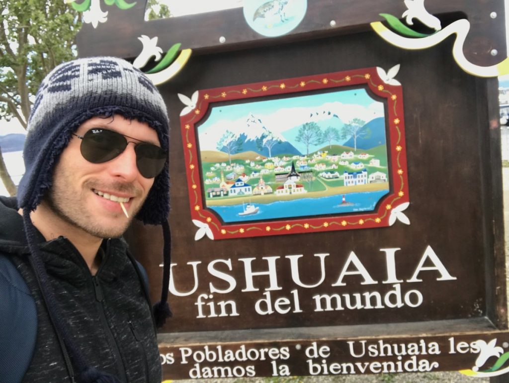 23 Best Things To Do in Ushuaia, Argentina | things to do in Ushuaia tourist at Ushuaia sign at the most southern point of Ushuaia