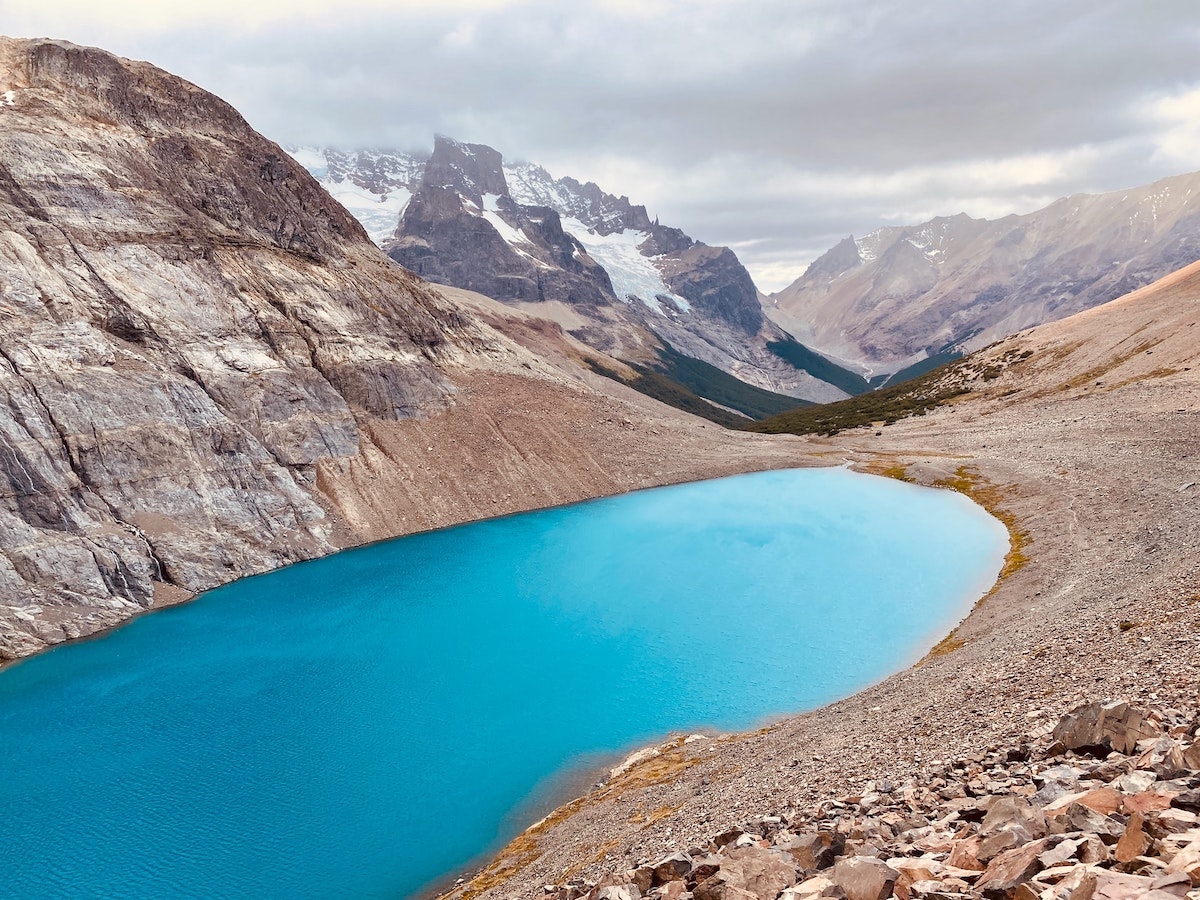 3 Weeks Patagonia Itinerary For Argentina & Chile | Cerro Castillo National Park Striking blue lake surrounded by brown rocky mountains in Cerro Castillo, Chilean Patagonia
