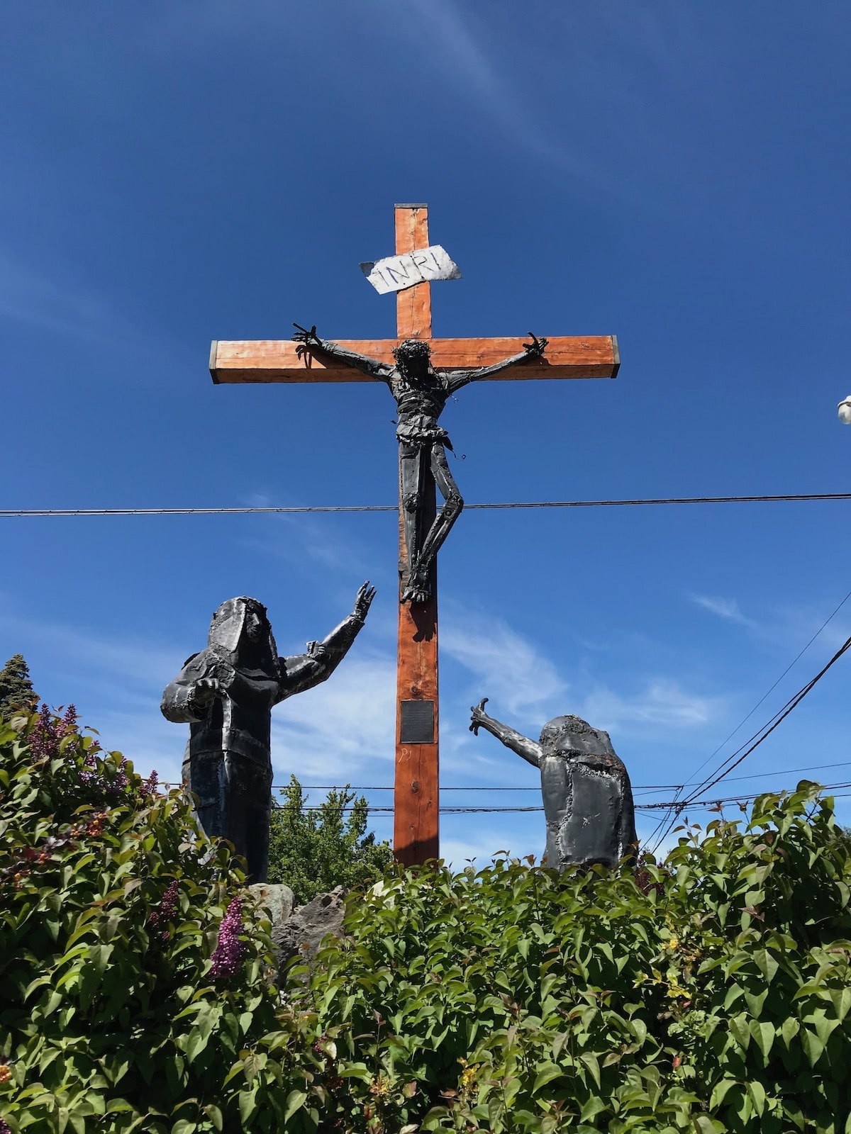 3 Weeks Patagonia Itinerary For Argentina & Chile | Christian statue Bariloche Christian statue of a cruxific with Jesus and two other figures with the backdrop of a blue sky in Argentina, Patagonia