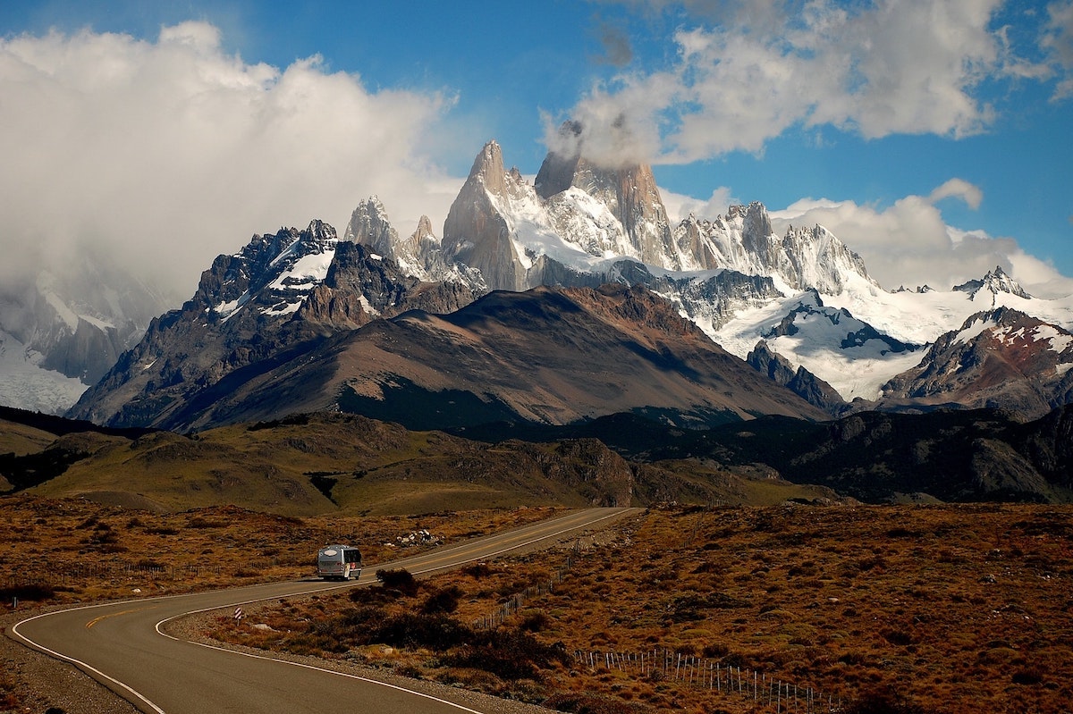 3 Weeks Patagonia Itinerary For Argentina & Chile | Fitz Roy Argentinian Patagonia Fitz Roy mountain standing out on a cloudy day behind a windy road in Patagonia, Argentina