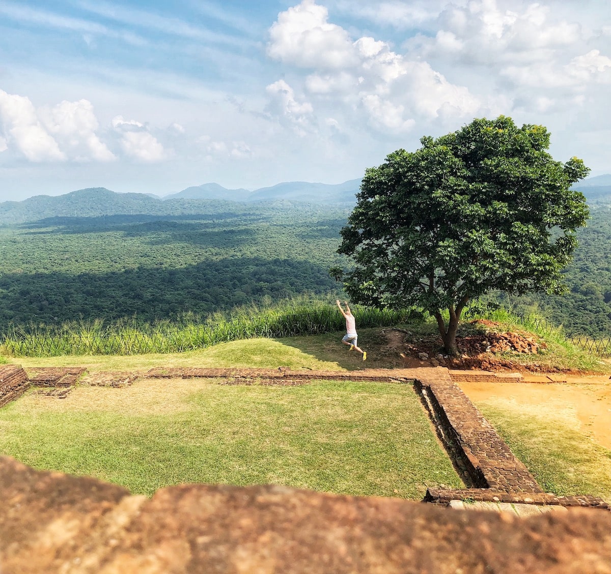 2 Weeks in Sri Lanka Itinerary For First-Timers | Sigiriya Rock Man jumping at Sigiriya Rock, Sri Lanka