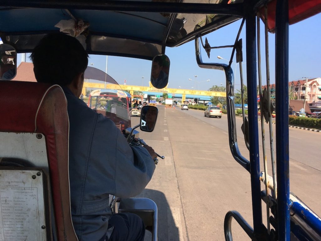 Cost of Living in Bangkok (& The Lies That Bloggers Tell) | Thailand visa run to Laos Approaching the Laos border from a tuk tuk during an overland visa trip from Thailand