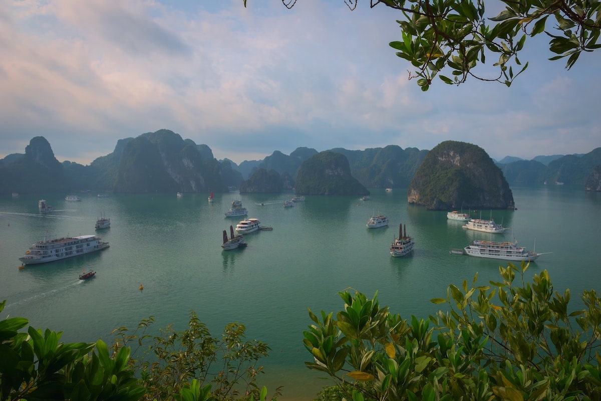 Best Vietnam Motorbike Routes: 5 Suggested Itineraries | ha long bay Boats passing through Ha Long Bay during the day