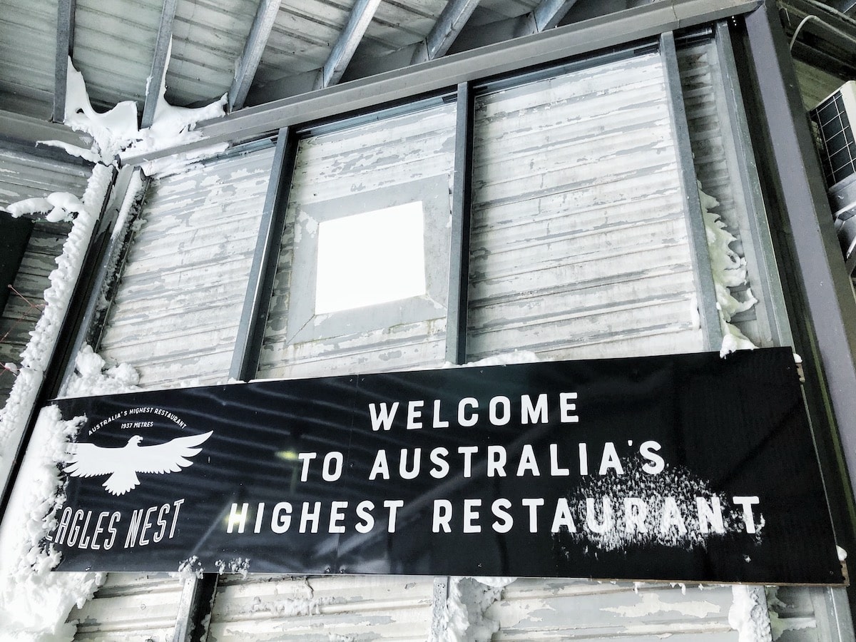 Climbing Mount Kosciuszko in Winter | highest restaurant in Australia A sign for Eagle's Nest, the highest restaurant in Australia