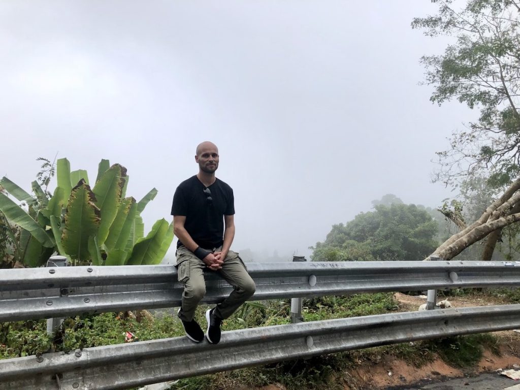 Loom Footwear Review: Versatile, Waterproof Trainers? | hiking in loom footwear Man posing in front of misty sky
