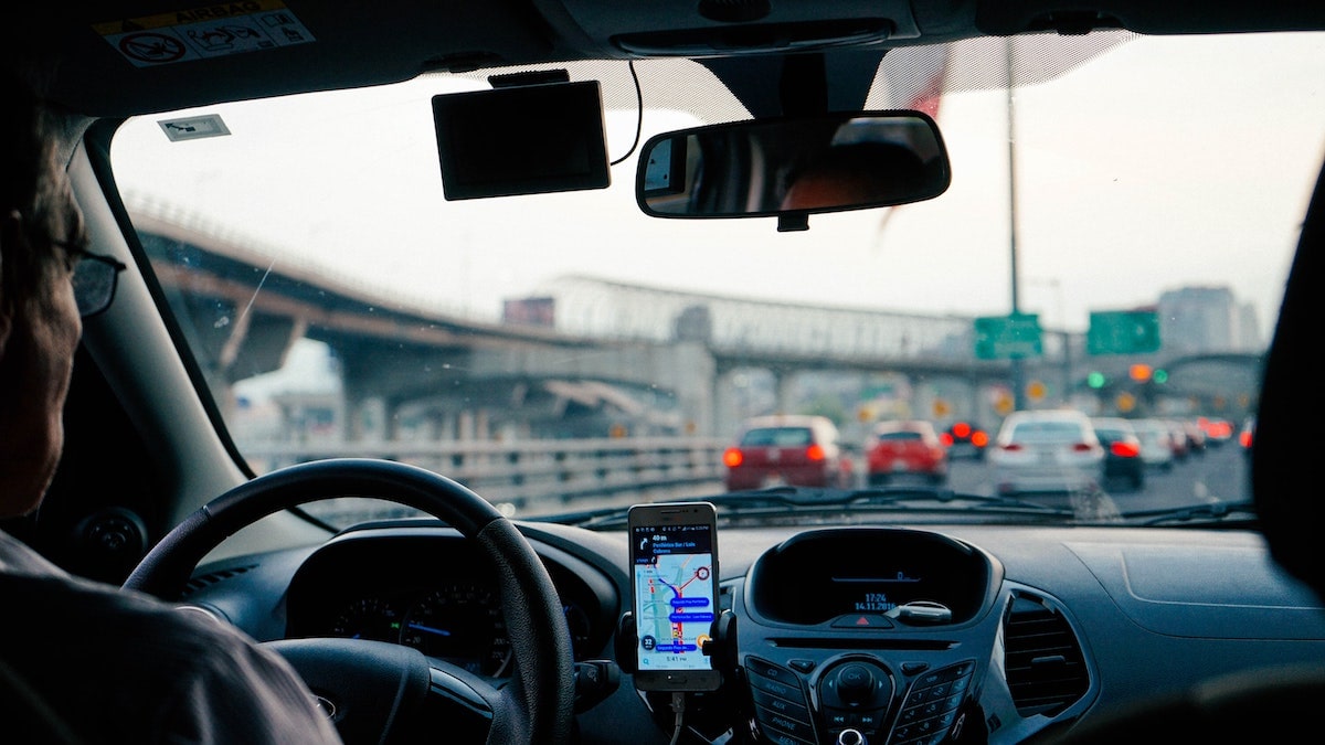 Cost of Living in Bangkok (& The Lies That Bloggers Tell) | private Driver looks out of car window into the traffic