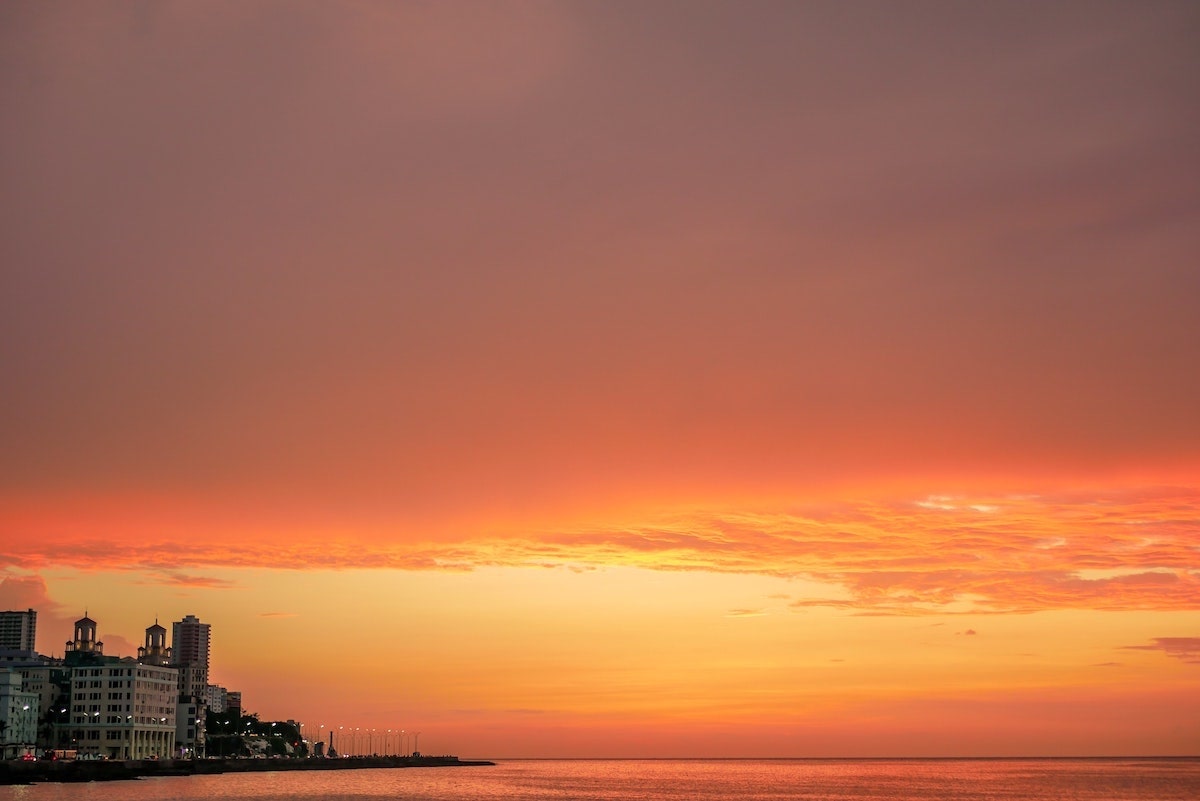 One Day in Havana Itinerary - Best Things To See & Do! | sunset malecon havana Stunning red sky sunset at the Malecon in Old Havana, Cuba