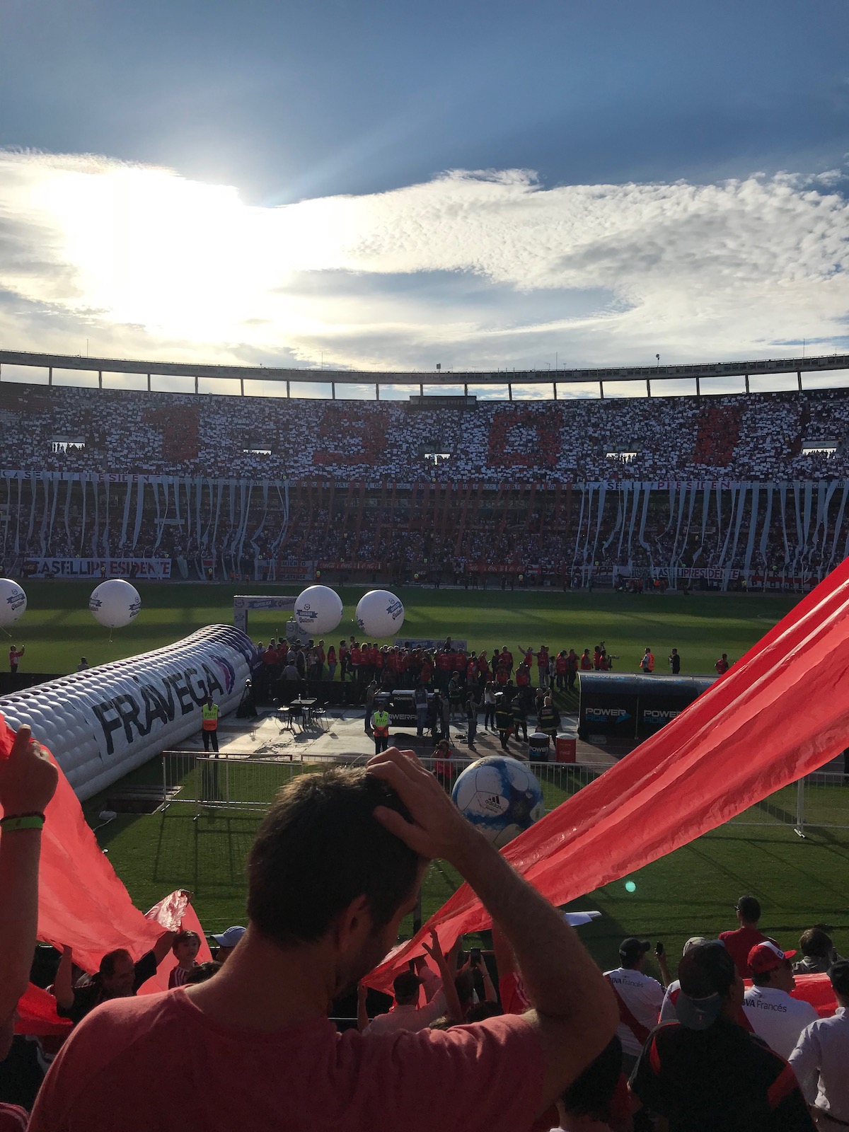 How To Buy Boca Juniors Tickets As A Tourist + Superclasico! | 1901 River Plate A packed football stadium in red and white contrast spells out the number "1901."