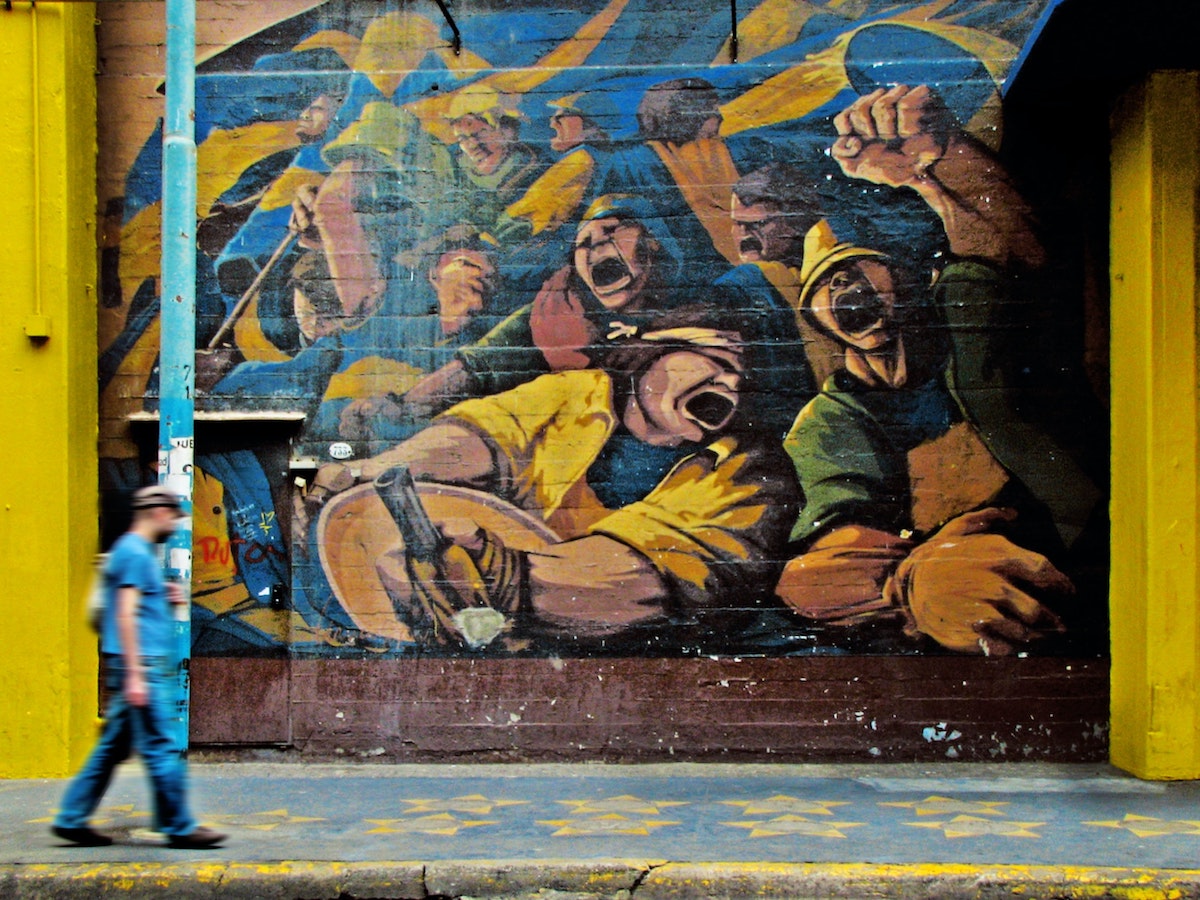 How To Buy Boca Juniors Tickets As A Tourist + Superclasico! | boca juniors graffiti Buenos Aires Man walks past graffiti depicting Boca Juniors supporters in Buenos Aires, Argentina