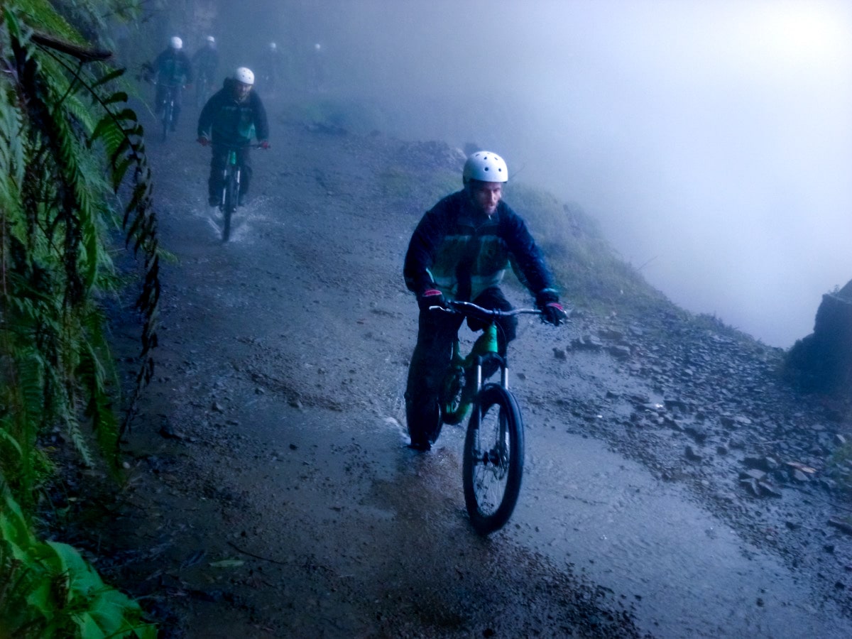 Cycling Down Bolivia's Death Road (How Not To Die!) | cycling death road bolivia A male tourist focuses hard as he is cycling down Bolivia's Death Road.