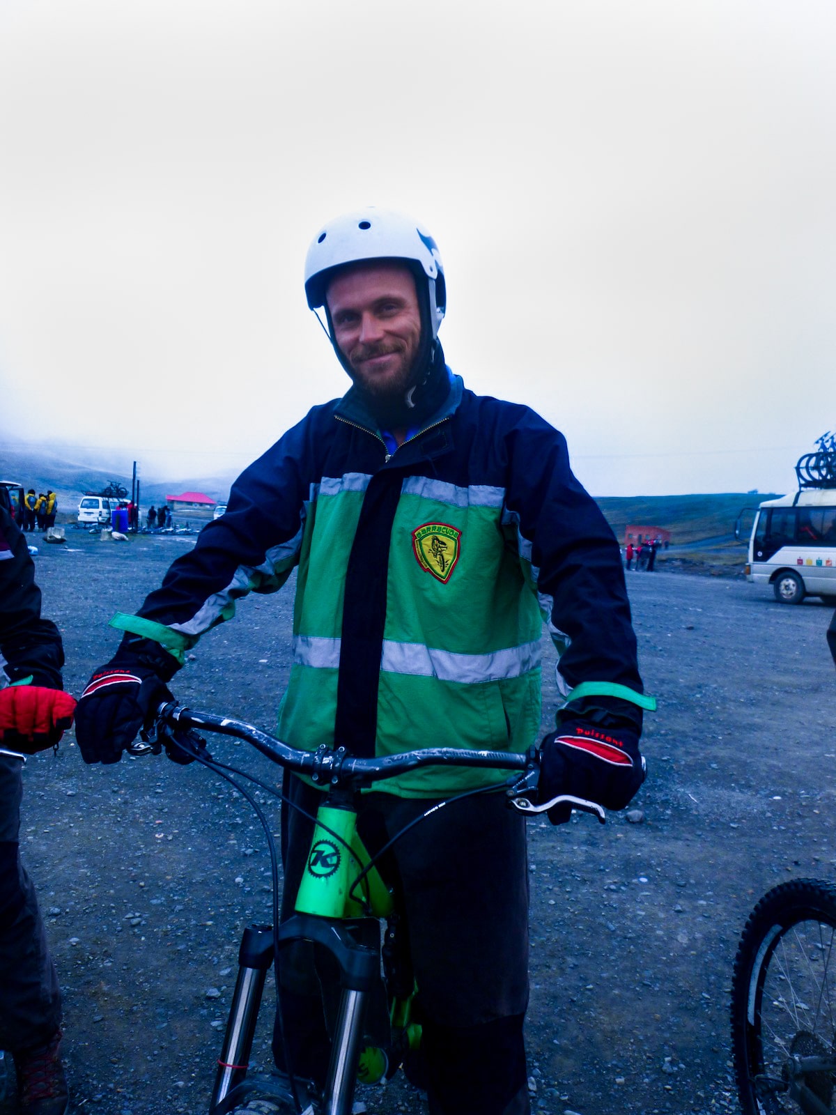 Cycling Down Bolivia's Death Road (How Not To Die!) | mountain bike gear death road bolivia Male cyclist in green smiles on his bike in La Paz, Bolivia.