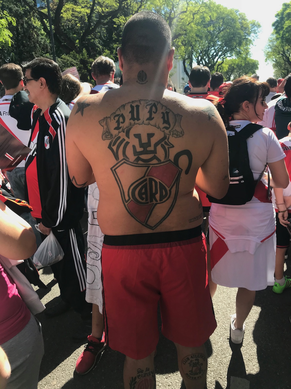 How To Buy Boca Juniors Tickets As A Tourist + Superclasico! | tattooed River Plate fan A football fanatic shows off a large crest of his club's crest, tattooed on his back in Buenos Aires, Argentina.