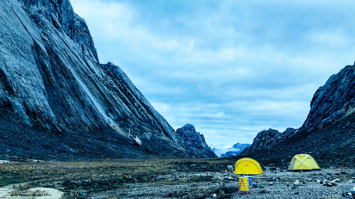 Climbing Puncak Jaya: How To Summit Carstensz Pyramid | Base camp for climbing Puncak Jaya Yellow tents at the base camp of Puncak Jaya
