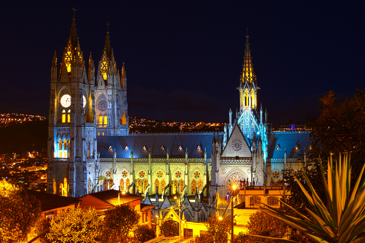 One Week in Quito, Ecuador: 23 Things in 7 Days! | Basilica del Voto Nacional A gothic building lit up at night in Quito, Ecuador.