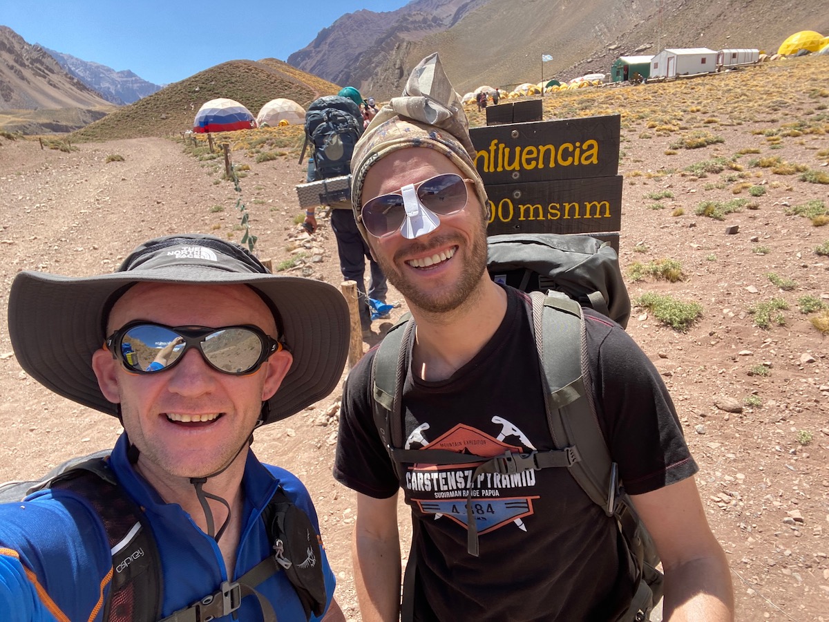 How Hard is it To Climb Aconcagua? | Camp Confluencia Acongaua Two hikers smile at Camp Confluencia during an Aconcagua hike