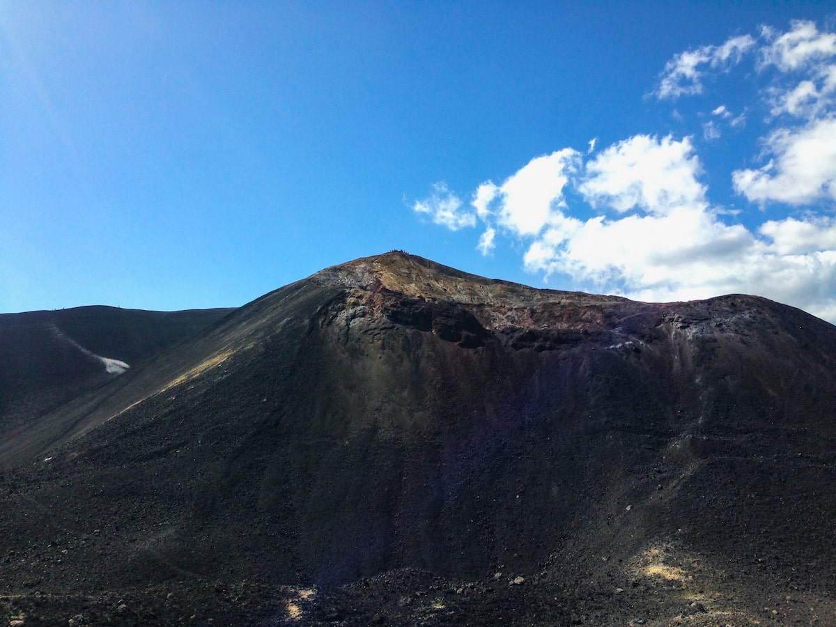 Volcano in Boarding in Leon, Nicaragua (Cerro Negro) | Cerro Negro Terrain A mountain with black volcanic ash from recent activity on a clear blue sky day in Nicaragua.