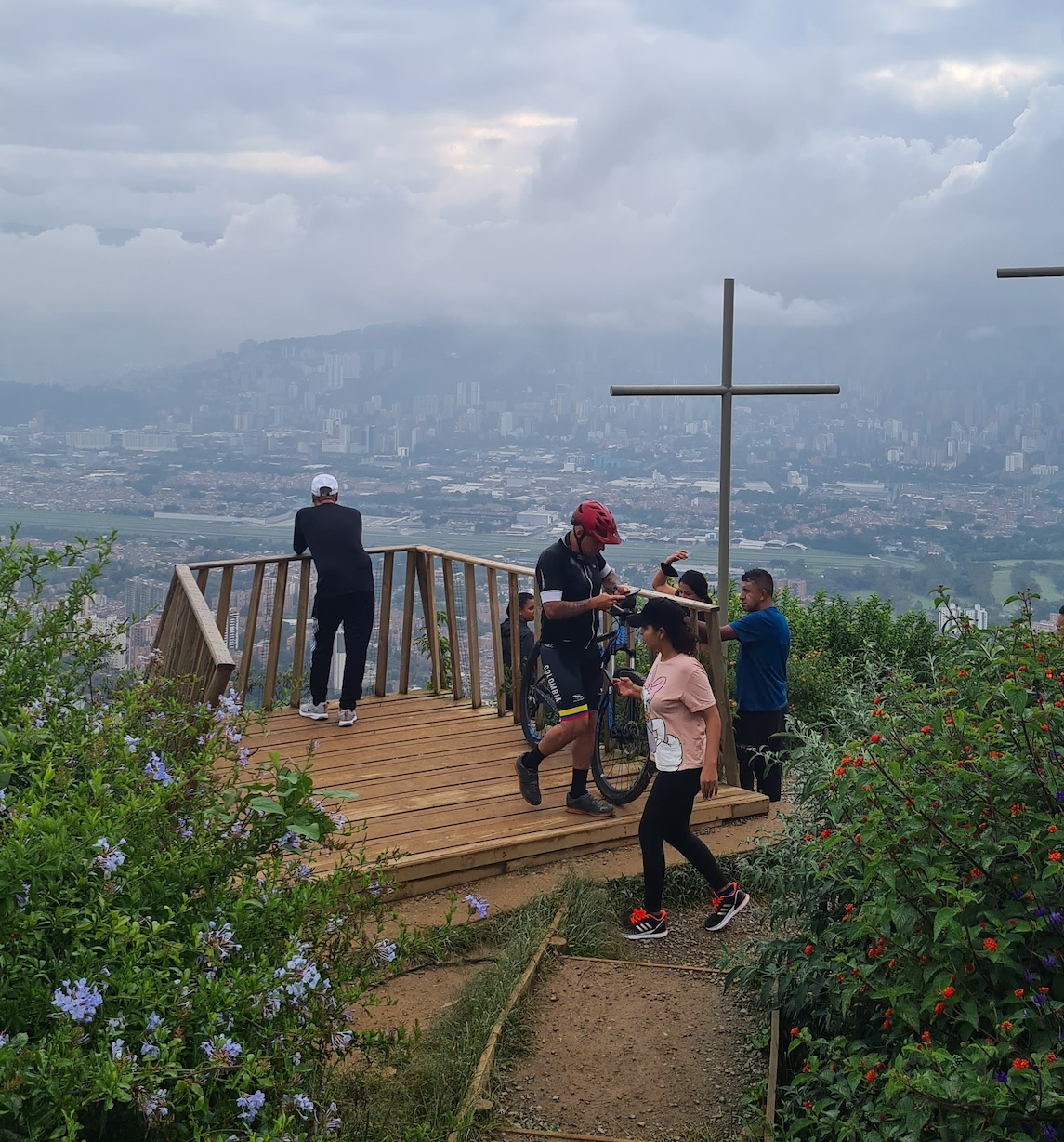 Expat's Guide To The Top Things To Do in Medellin, Colombia | Cerro de las Tres Cruces Medellin Hikers look out from a viewpoint on a misty day at the hill of three crosses in Medellin, Colombia