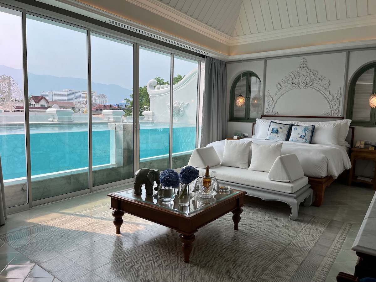 Detailed Chiang Mai Digital Nomad Guide For 2024 | Chiang Mai hotel A hotel room with white bedding and a private pool overlooks large mountains in Old Town, Chiang Mai