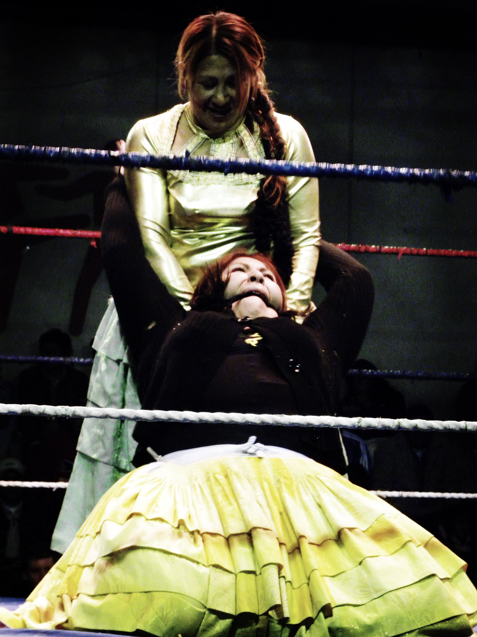28 Best Things To Do in La Paz, Bolivia & Surrounding Areas | Cholita wrestling A female wrestler smiles as she holds another female fighter during a wrestling match in La Paz, Bolivia