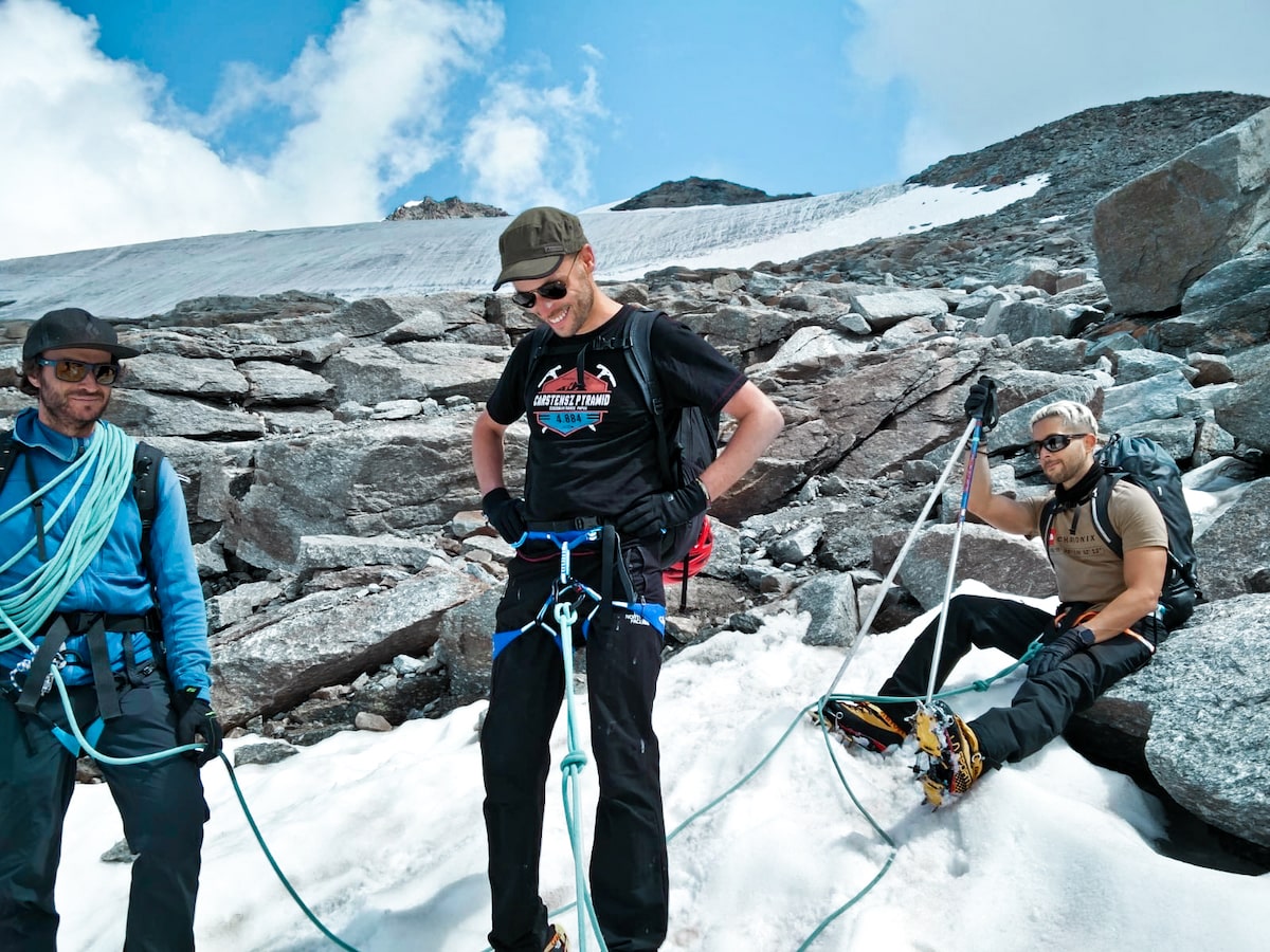Mont Blanc Climb (The Beginner's Guide To Summiting in 2024) | Climbers on Gran Paradiso Three mountain climbing men pause for a smile as they rope themselves together.