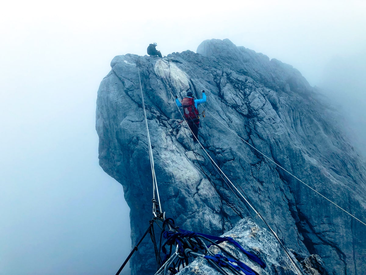 Climbing Puncak Jaya: How To Summit Carstensz Pyramid | Coming down Puncak Jaya A female climber walks the infamous scary Rope Bridge on Puncak Jaya, also known as Carstenz Pyramid.