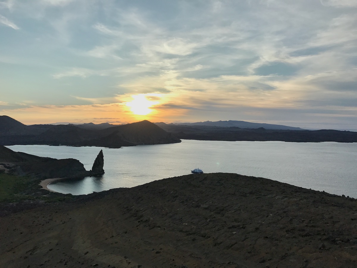5 Days in The Galapagos Islands Itinerary (On a Cruise) | El Barranco Galapagos Islands A cruise ship floats at sunset on El Barranco Island during a 5 days Galapagos Islands cruise