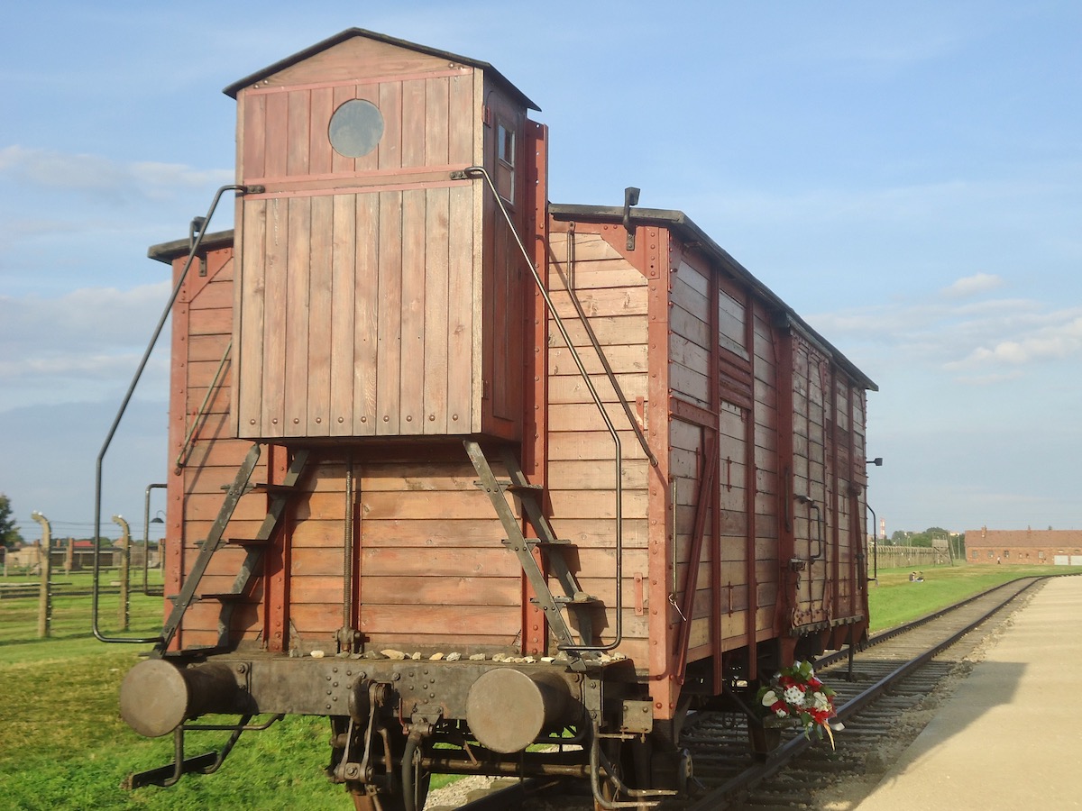 Visiting Auschwitz: All You Need To Know & What To Expect | Holocaust trains A former holocaust train stands on the railway in the Auschwitz museum.