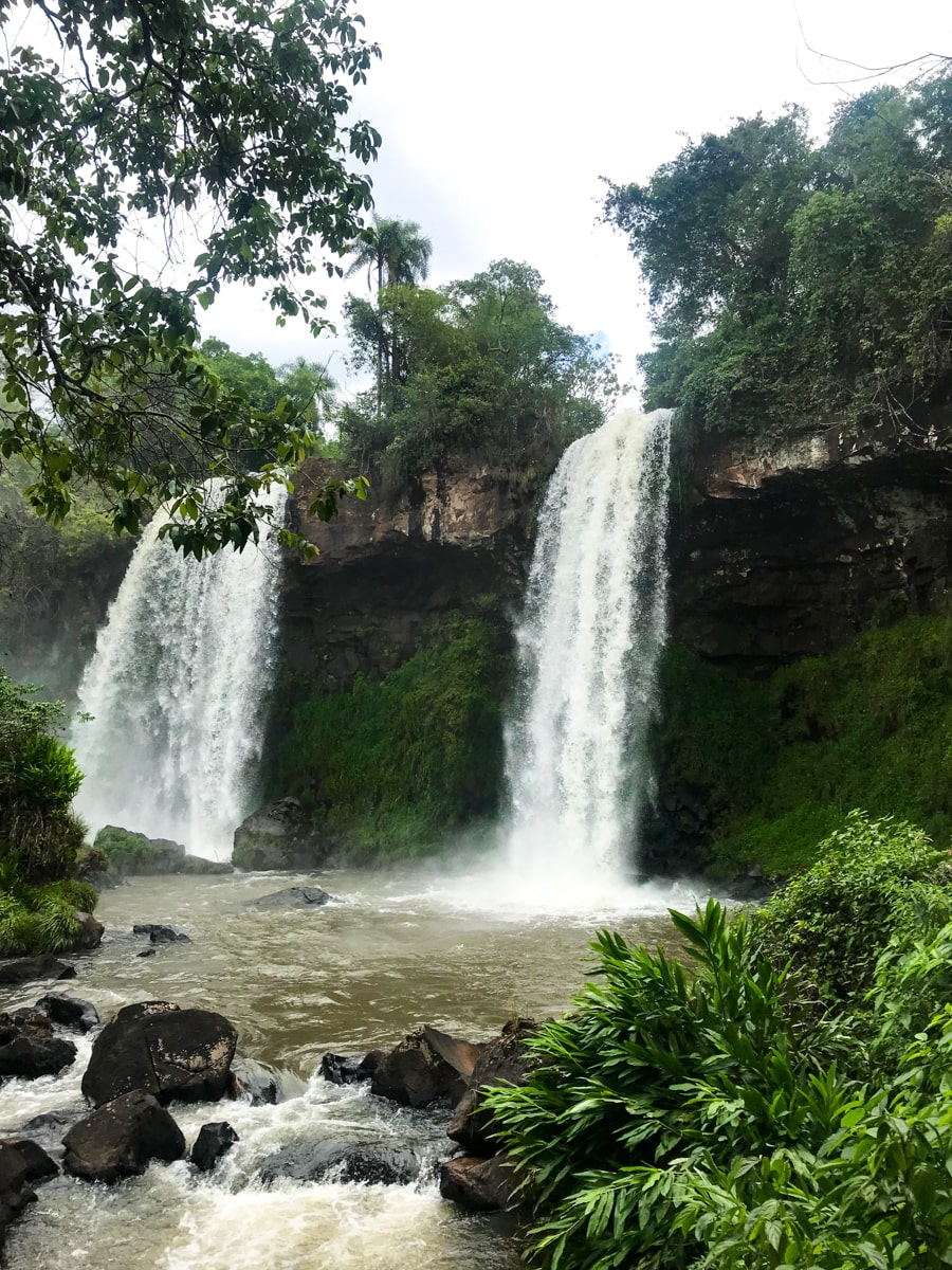 The Ultimate Guide To Visiting Both Sides of Iguazu Falls | Iguazu National Park Argentina Two large waterfalls flow in Iguazu National Park, Argentina