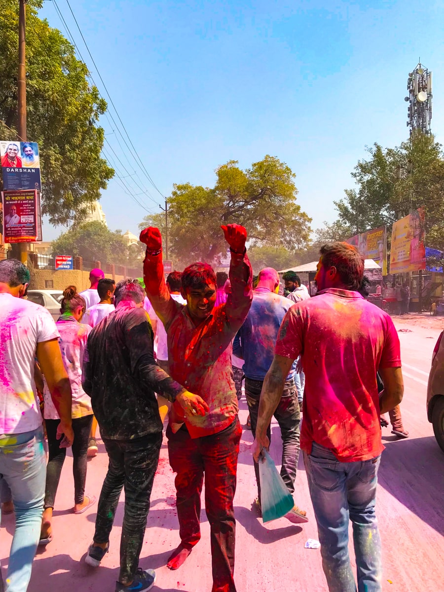 The Worst of The Holi Festival in India | Indian man throwing powder at holi festival A man throws powder during Holi in the street during the day