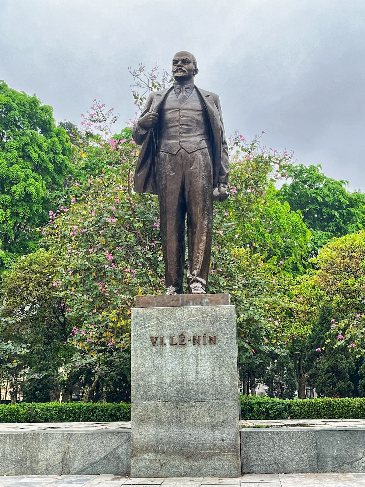 One Day in Hanoi Itinerary: No Transport Needed (Walking Only!) | Lenin Park Hanoi A bronze statue of Vladimir Lenin in front of green trees