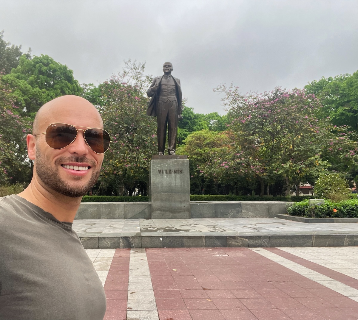 One Day in Hanoi Itinerary: No Transport Needed (Walking Only!) | Lenin Park Vietnam A tourist poses in front of a statue of Vladimir Lenin in Hanoi, Vietnam