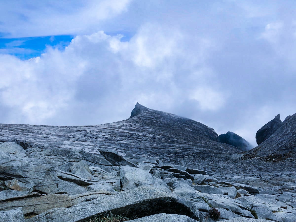 Climbing Mount Kinabalu Tips & Info For First-TimersĀ | Lows peak Mount Kinabalu A mountain ridge above the clouds.