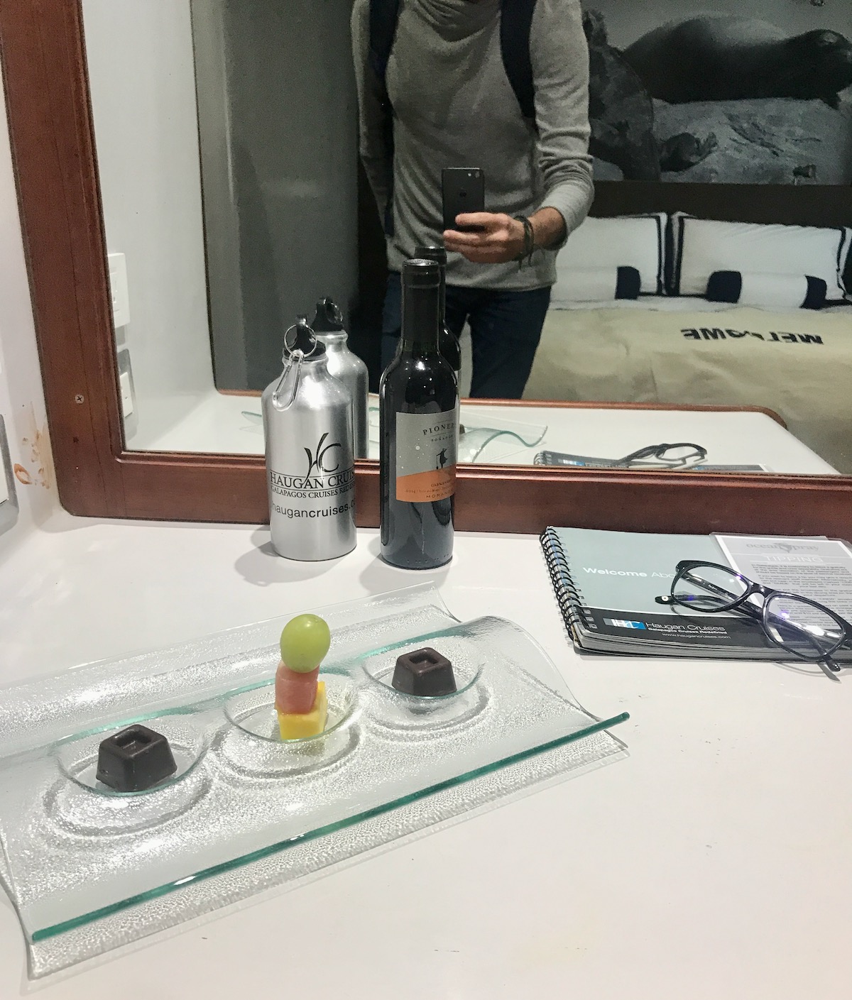 5 Days in The Galapagos Islands Itinerary (On a Cruise) | Luxury Galapagos Cruise bedroom A tourist takes a photo in the mirror of a Luxury Galapagos Cruise bedroom