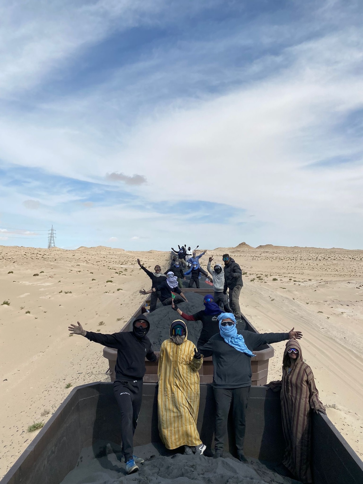 Riding The Iron Ore Train, Mauritania: My Sahara Experience! | Mauritania train tourists Tourists pose on top of the iron ore train of Mauritania