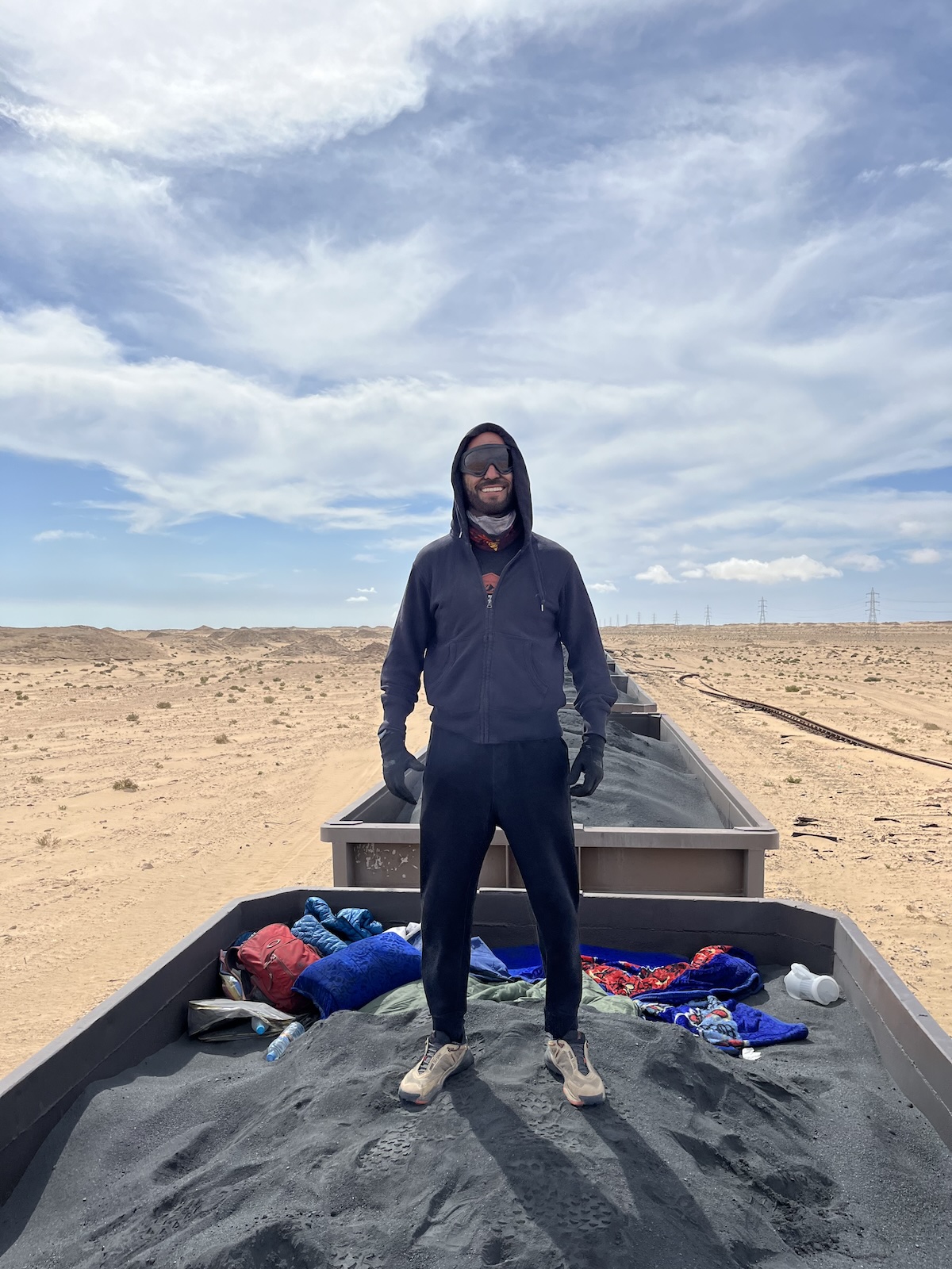 2023 Review: Turning 40, Feeling Good & Plans For 2024 | Me Iron Ore Mauritania 2 A man in sunglasses smiles while standing on the Iron Ore Train in Mauritania