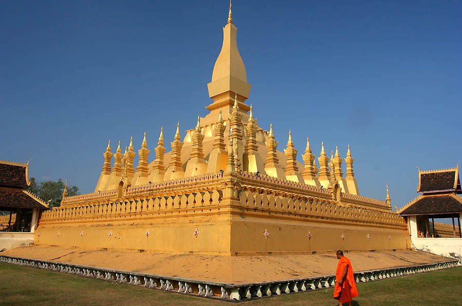 15 Things To Do in Vientiane, Laos (Includes Day Trips) | Pha That Luang Vientiane Laos 1 1 A monk in orange walks past a beautiful large golden temple in Vientiane, Laos