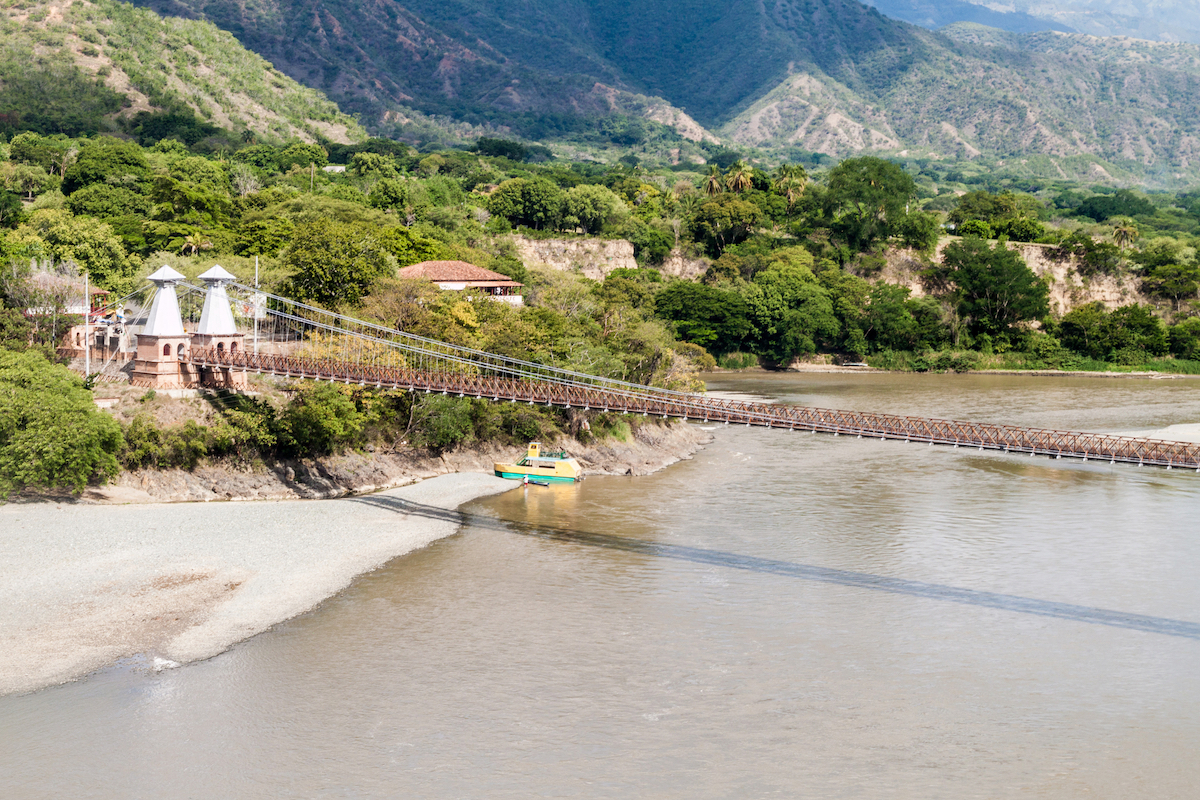 13 Brilliant Weekend & Day Trips From Medellin | Puente de Occidente A large bridge across a body of water in Santa Fe de Antioquia, Colombia