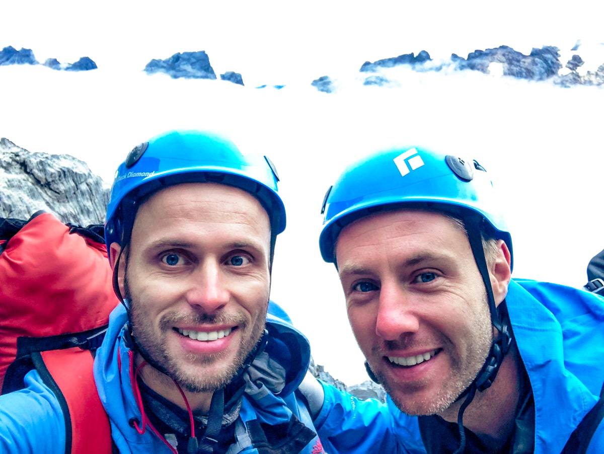Climbing Puncak Jaya: How To Summit Carstensz Pyramid | Puncak Jaya gear Two male climbers smile while climbing Puncak Jaya