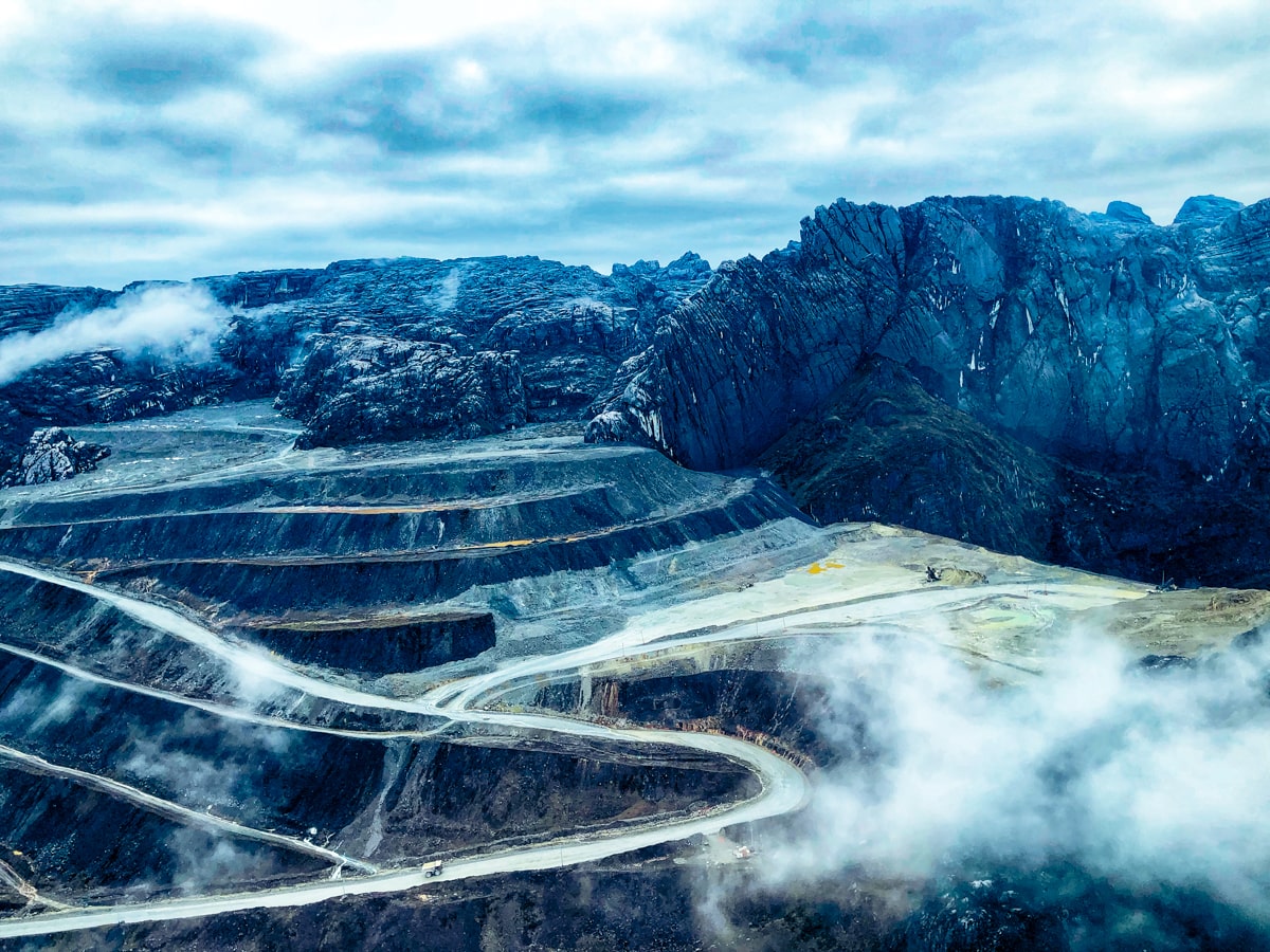 Climbing Puncak Jaya: How To Summit Carstensz Pyramid | Puncak Jaya goldmine aerial view of Grasberg Mine near Puncak Jaya