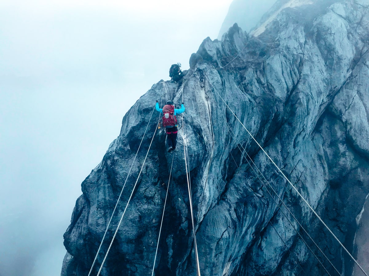Climbing Puncak Jaya: How To Summit Carstensz Pyramid | Rope bridge Puncak Jaya A climber walks the Rope Bridge on Carstenz Pyramid