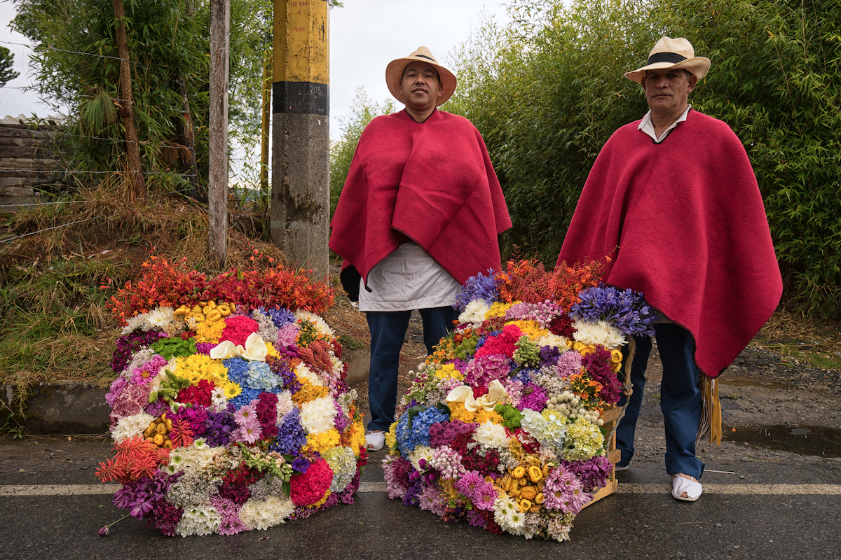 13 Brilliant Weekend & Day Trips From Medellin | Santa Elena Medellin Farmers posing with floral displays made for the annual flower festival parade in Santa Elena, Colombia